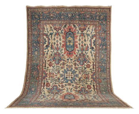 An impressive Ushak carpetWest Anatoliaon cream ground with strong pink and indigo wools throughout, the whole surrounded by 