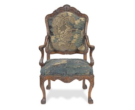 A Louis XV carved solid walnut fauteuil or open armchairWith late 17th/early 18th century verdure tapestry upholstery, the fr