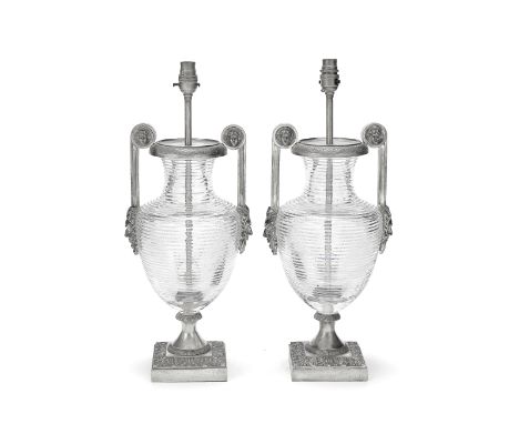 A pair of mid-20th century silvered metal and cut glass urn lamp basesin the Empire style, possibly Americanthe ribbed ovoid 