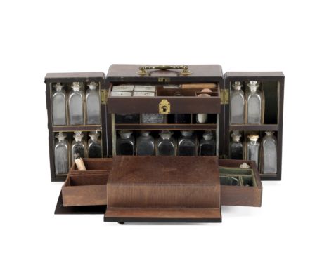 An Unusual Mahogany Medicine Chest, English, circa 1830,with double doors and folding drawer opening to twenty glass bottles 