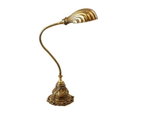 A 1920's English brass adjustable desk lamp with scalloped shaped shade, height 46cm
***CONDITION REPORT***Good untouched con