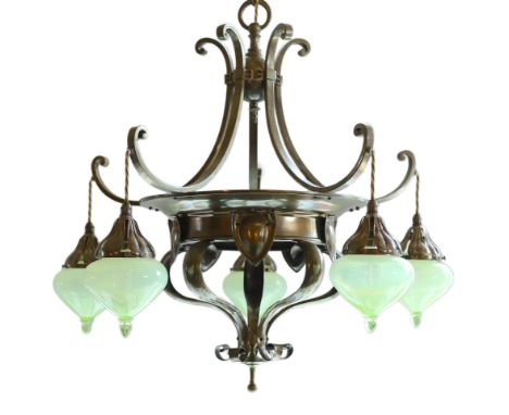 An English Arts &amp; Crafts brass light fitting by Faraday &amp; Son, of circular scrolling design, hung with five green vas