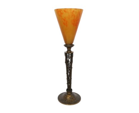 An early 20th century French bronze table lamp attributed to Daum, with pate de verre orange glass uplighter shade, height 42
