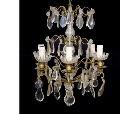 An early 20th century French bronze and cut glass six light chandelier hung with tear and lozenge shaped drops, drop 50cm, wi