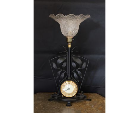 A 1930's English wrought iron table lamp inset with a Smiths Sectric timepiece, overall height 40cm
***CONDITION REPORT***Goo