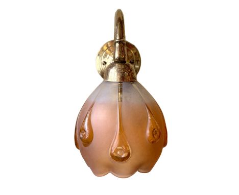 An early 20th century French brass wall light of Art Nouveau influence, with amber tinted glass shade, depth 22cm, height 23c