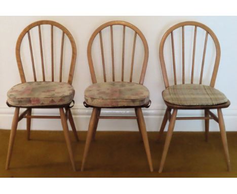 Set of three Ercol mid 20th century light wood stick back chairs. Approx. 85cm H

All in reasonable used condition, scuffs an