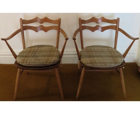 Pair of Ercol mid 20th century light wood armchairs. Approx. 73cm H

Reasonable used condition, scuffs and scratches 