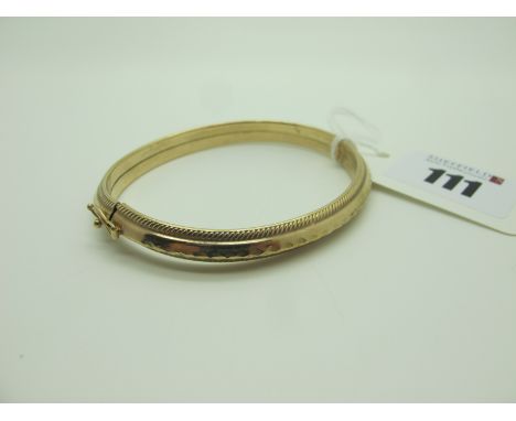 A Decorative 9ct Gold Bangle, with textured decoration (6.9grams). 