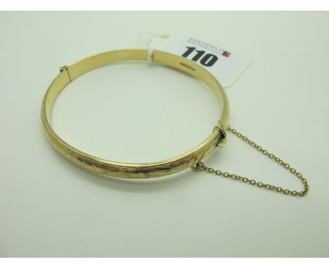 A 9ct Gold Hinged Bangle, engraved to to front (8.5grams). 