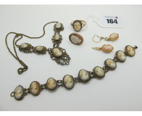 A Vintage Shell Carved Cameo Inset Bracelet, a graduated necklace, a pair of cameo earrings and a cameo dress ring (damages /