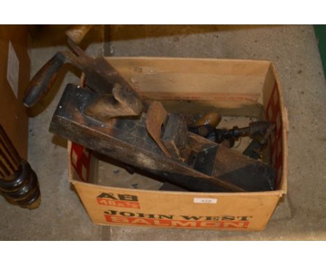A box of various tools to include a wood working plane 