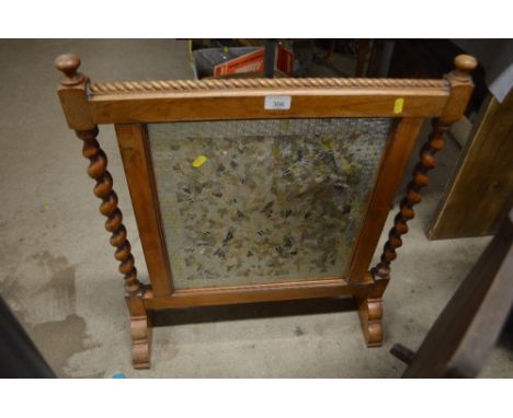A mahogany framed firescreen flanked by barleytwist columns 