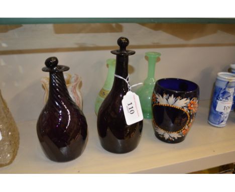 A small 19th Century amethyst glass decanter; another similar of swirl design; two green glass scent flasks; a Latachino styl