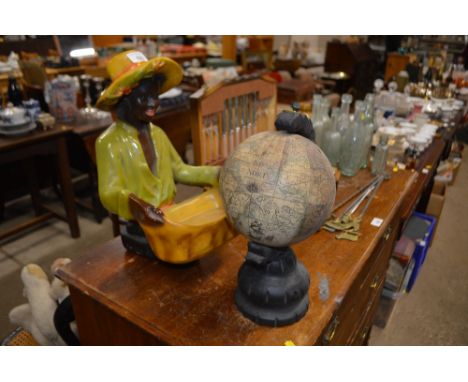 A world globe on stand; and a painted plaster figure holding a basket