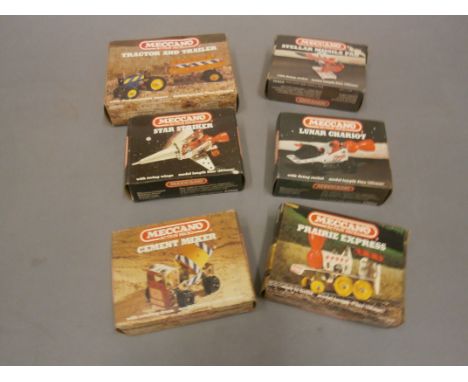 Six boxed Meccano Action Packs comprising of Star Striker, Prairie Express, Lunar Chariot, Stellar Missile Pad, Tractor and T