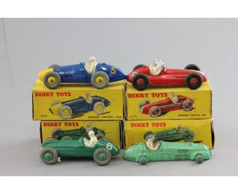 Four boxed Dinky racing cars to include 23N Maserati in red with white, red hubs (some paint loss), 23H Ferrari in blue with 