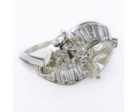 Approx. 3.69 carat TW Diamond and Platinum Bypass Ring. Set with an approx. 1.47 carat pear shape diamond, K color, VS clarit