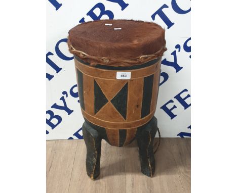 AN AFRICAN TOURIST ANIMAL SKIN AND WOODEN DRUM ON TRIPOD BASE