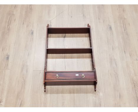 A REPRODUCTION MAHOGANY WALL HANGING SHELF WITH DRAWER