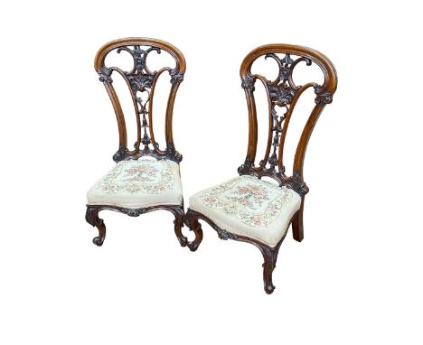 Pair Victorian mahogany open spoon back nursing chairs with floral tapestry seats.