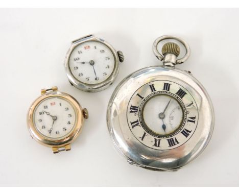 A 9ct gold ladies watch head, with white enamel face and Arabic numerals, a silver ladies watch head with white enamel face a