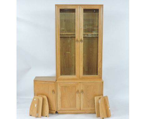 A modern Ercol light elm modular side cabinet, with glazed upper section, with cupboards beneath, together with a low side cu