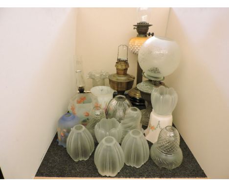 A quantity of various 19th century and later glass lampshades, a Victorian oil lamp with basket weave reservoir