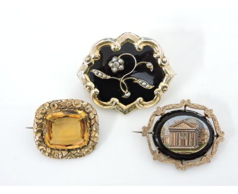 A rolled gold black enamel memorial brooch, set with a single rose cut diamond and split pearl scrolling flower, with locket 