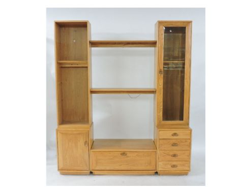 A modern Ercol light elm modular entertainment unit, low television stand flanked by glazed cupboard and shelves, and a low b