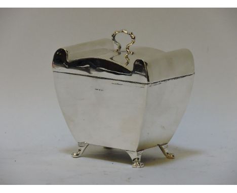 An Edwardian silver tea caddy, Chester 1909, on lion paw feet