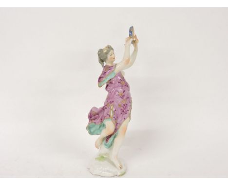 A Continental porcelain figure of a lady playing a tambourine, 23cm high (damage)
