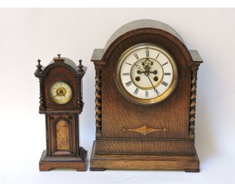 A Victorian oak cased mantle clock, the white dial with visible escapement, and a miniature long case clock, with tick 'tac' 