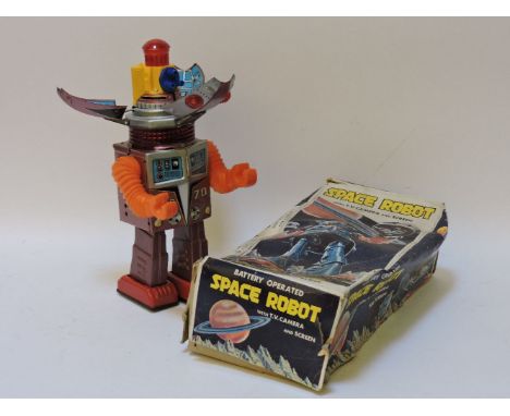 A Nomura 'Space robot X-70', with TV camera and screen, battery operated, with purple and silver lithograph tin plate body wi