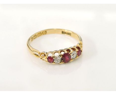 An 18ct gold boat shaped graduating five stone ruby and diamond ring