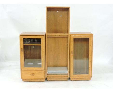 A modern Ercol light elm stereo cabinet, with glazed door, 49cm wide, together with a free standing narrow bookshelf, 47cm wi