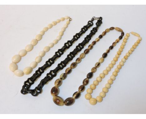 A single row of graduated olive shaped ivory beads, a single row of graduated circular bone beads, a single row of graduated 