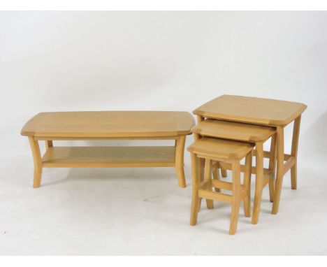 A modern Ercol light elm low occasional table, together with a matching set of nesting tables