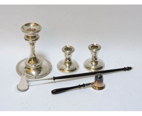 A pair of silver candlesticks, together with a further single silver candle stick and a two silver candle d ?? with turned eb