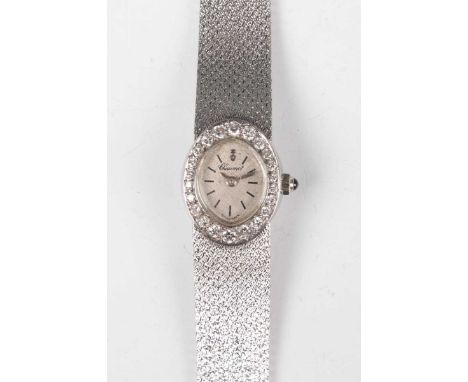 A Corum 18ct white gold and diamond set lady's bracelet wristwatch with signed and jewelled movement, the silvered dial with 