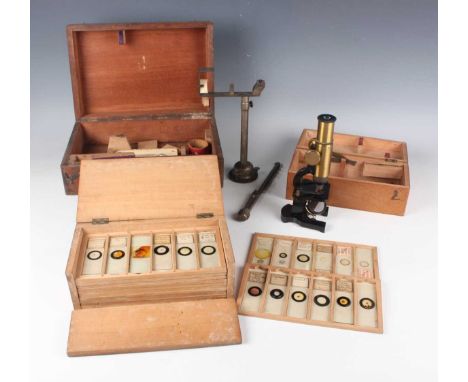 An early 20th century gilt lacquered brass and black enamelled monocular microscope, cased, and a collection of seventy-two m