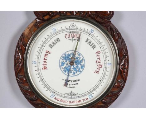 A late Victorian walnut wheel barometer with mercury thermometer and glass dials, inscribed 'J.H Steward... London', the case