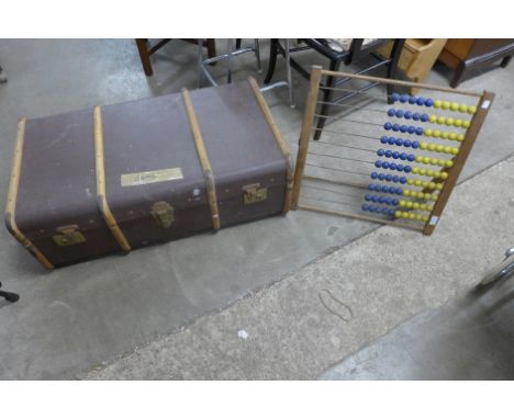 A vintage child's abacus and a steamer trunk