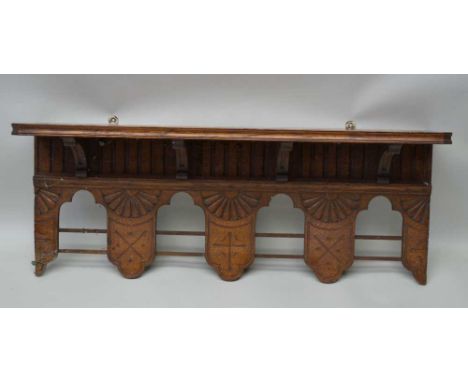 AN OAK NEO-GOTHIC DESIGN WALL SHELF, with arcaded frieze, cross motif to central lower section, 76cm wide Condition report: o