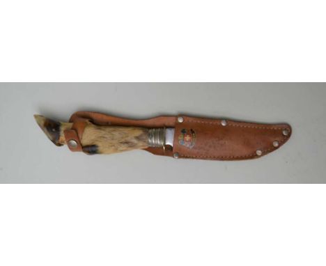 A MID-20TH CENTURY EUROPEAN HUNTING KNIFE with deer slot handle, the blade engraved "Schneidteufel Solingen" in leather belt,