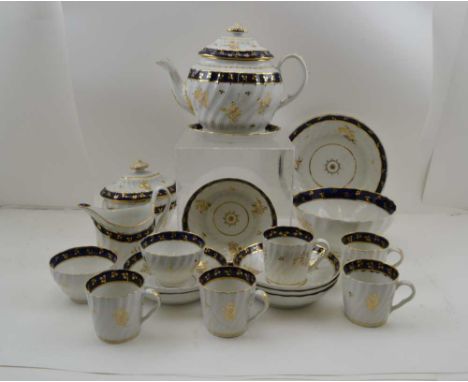 AN EARLY 19TH CENTURY PORCELAIN PART TEA SET, in the manner of Worcester, wrythen bodies with cobalt blue bands and gilt spri