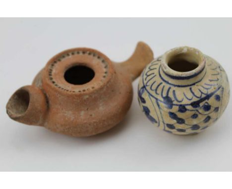 A ROMAN TERRACOTTA OIL LAMP together with a small painted vase, 5cm high 