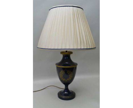 AN URN FORM TABLE LAMP, blue painted metal with gilded acorn &amp; oak leaf wreath, fitted a pleated cream shade with blue de