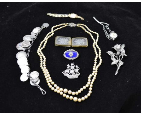 A TWO STRAND PEARL NECKLACE with silver clasp, a silver coin mounted BRACELET, THREE MARCASITE BROOCHES, a BELT BUCKLE of int