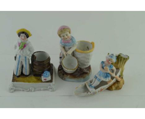 THREE CONTINENTAL CERAMIC VESTA HOLDERS / STRIKERS, figuratively moulded, one in the form of a boat, 8.5cm high (3) 